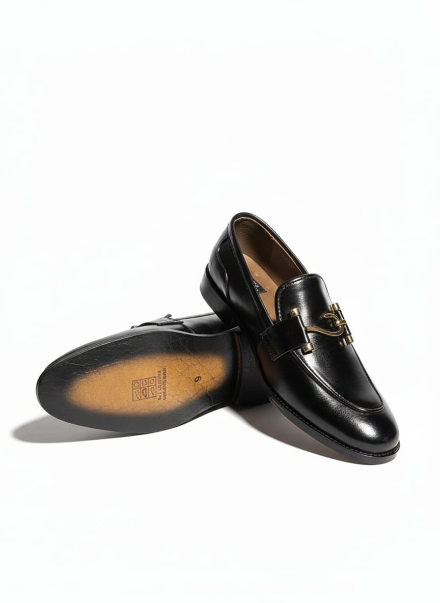 Black leather loafers with gold-tone horsebit.